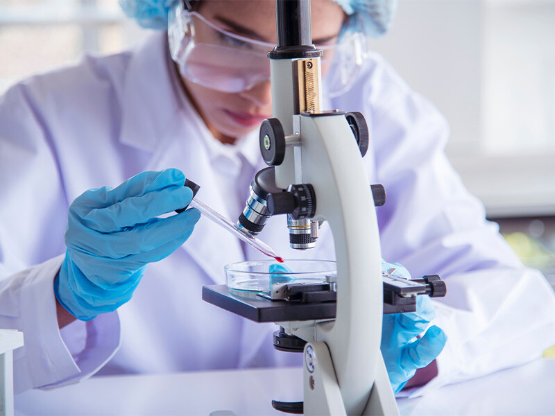 Woman scientist in lab look at science microscope medical test and esearch biolog chemistry